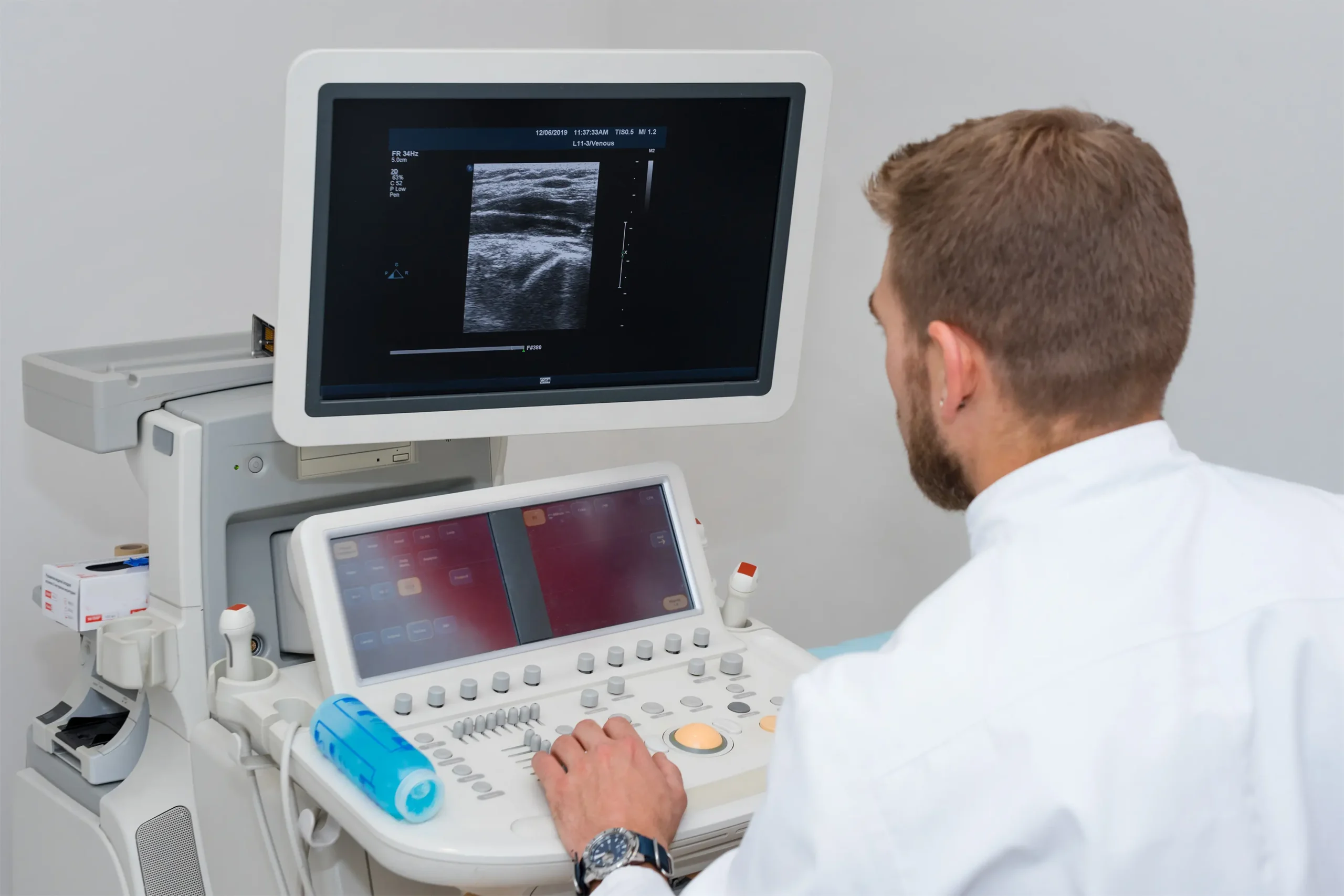 doctor white uniform with ultrasound device surgeon man with diagnostic equipment phlebologist working moder clinic medical tools hospital